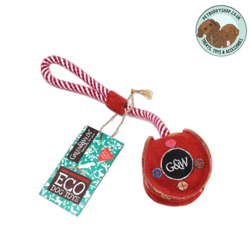 Red Christmas bauble dog toy with a red and white striped jute rope handle on a white background.