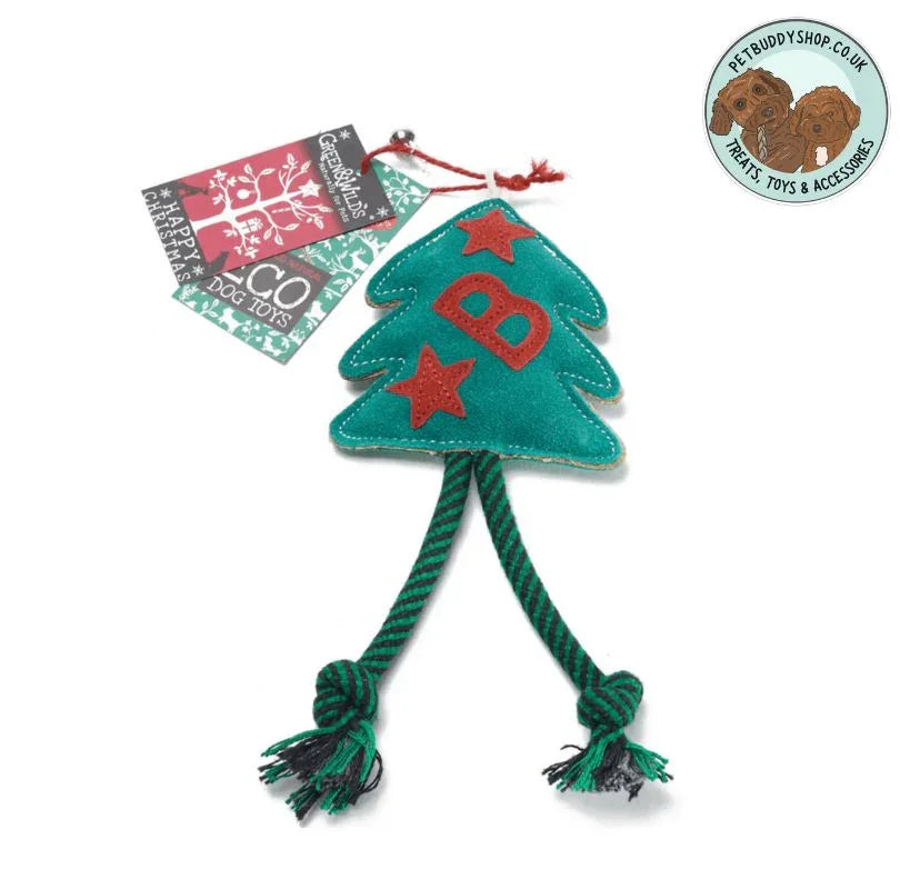 Green dog toy shaped like a Christmas tree with a red B and two reed stars sown into it with two green knotted rope legs on a white background.