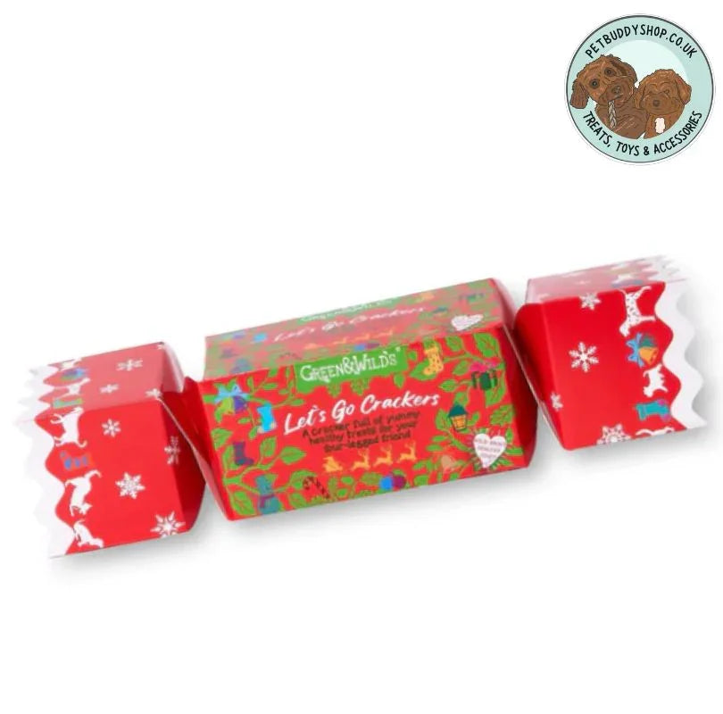 Red and green Christmas cracker filled with natural dog treats with 'Green & Wilds' branding on a white background.